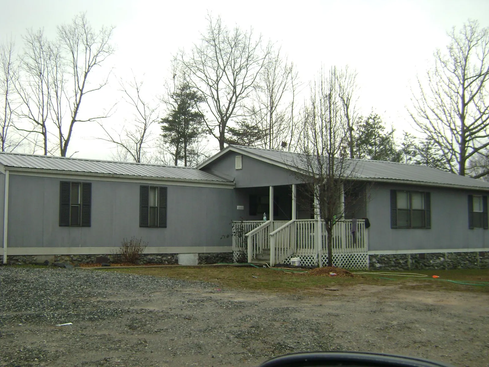 Metal roof over a manufactured home with a covered front porch in Wirtz